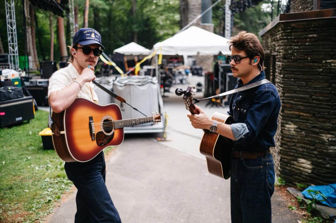 Two guitarists warming up backstage