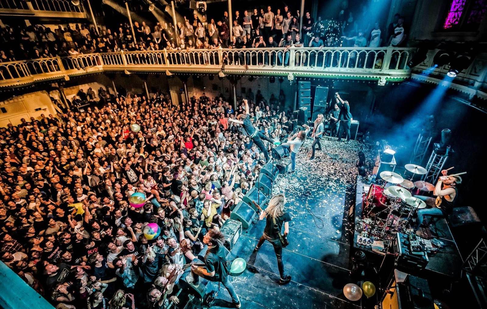Concert crowd at a packed venue, seen from above